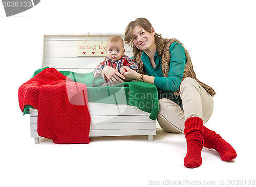 Image of Baby boy in old box with his mother