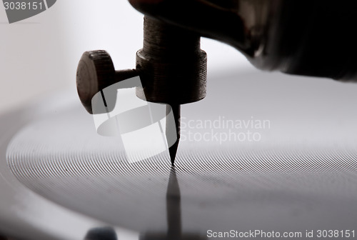 Image of gramophone needle playing record