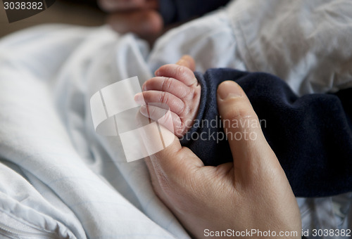 Image of baby hand mother hand