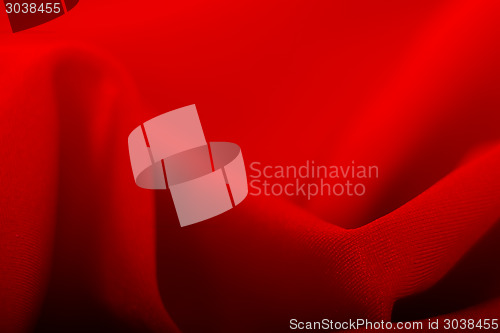 Image of Beautiful background. Red fabric waves. macro