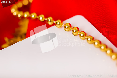 Image of card. Red fabric with festive beads