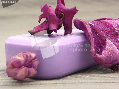 Image of Lilac soap with decoration articles on a  gray  background