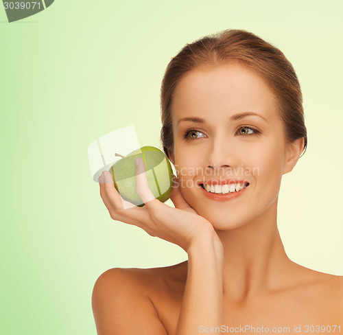 Image of smiling young woman with green apple