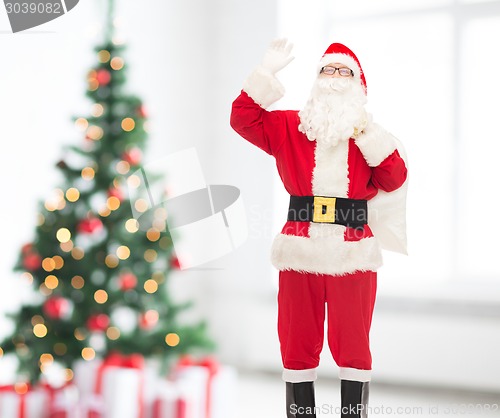 Image of man in costume of santa claus with bag