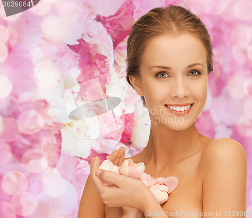 Image of beautiful smiling young woman with flowers