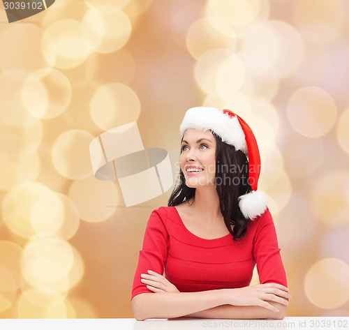 Image of smiling woman in santa helper hat