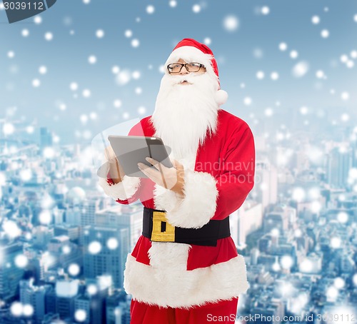 Image of man in costume of santa claus with tablet pc