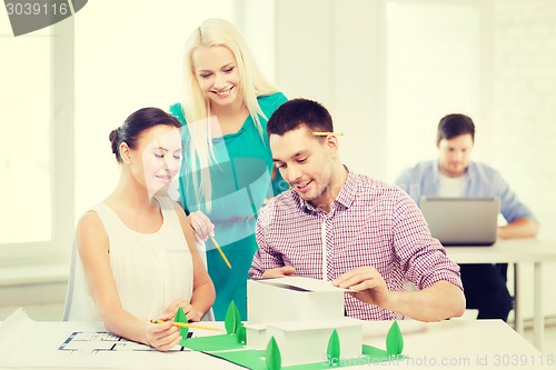 Image of smiling architects working in office