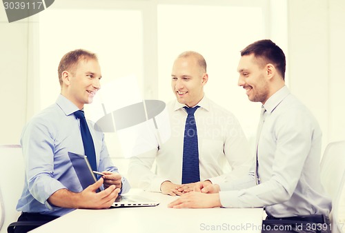 Image of business team working with laptop in office