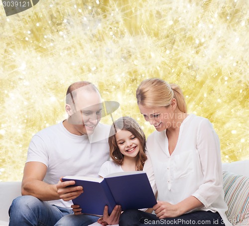 Image of happy family with book at home