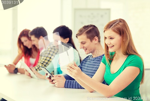 Image of smiling students with tablet pc at school