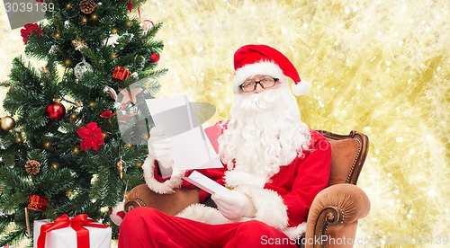 Image of man in costume of santa claus with letter