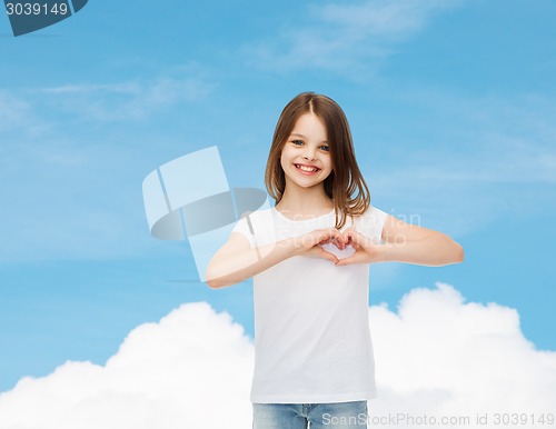 Image of smiling little girl in white blank t-shirt