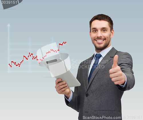 Image of young businessman showing thumbs up gesture