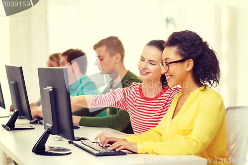 Image of smiling students in computer class at school