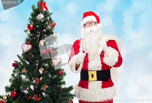 Image of santa claus with bag and christmas tree