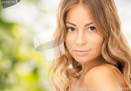 Image of beautiful young woman over green background