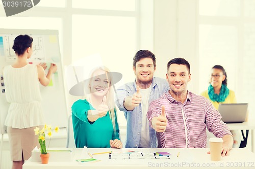 Image of smiling interior designers working in office