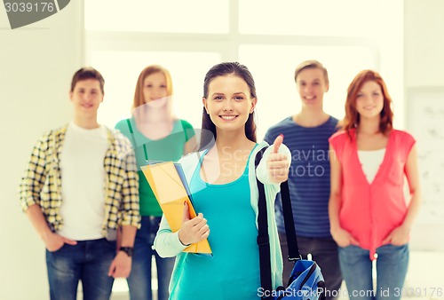 Image of smiling students with teenage girl in front