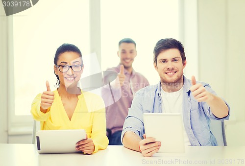 Image of smiling team with tablet pc computers at office