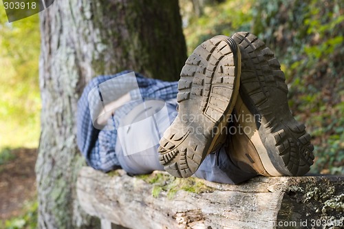 Image of Hiker lying on a wooden bench