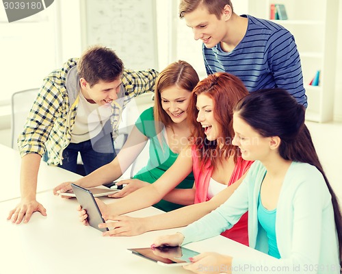 Image of smiling students with tablet pc at school