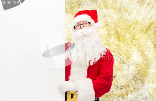 Image of man in costume of santa claus with billboard