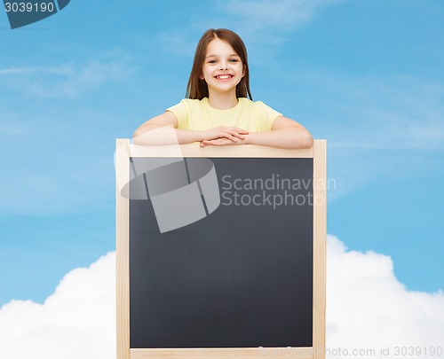 Image of happy little girl with blank blackboard