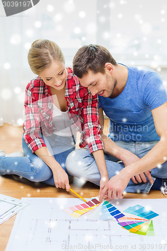 Image of smiling couple selecting color from samples