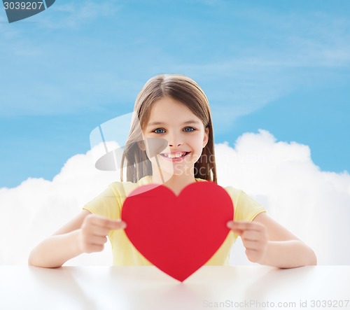 Image of beautiful little girl sitting at table