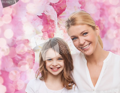 Image of smiling mother and little girl