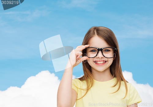 Image of smiling cute little girl in black eyeglasses