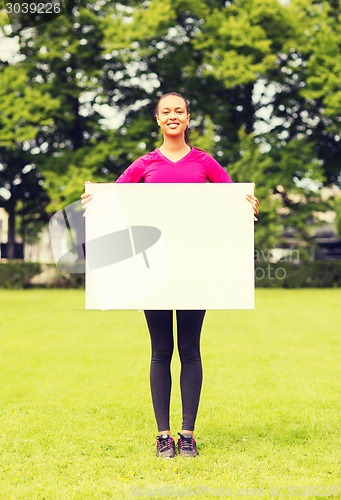 Image of smiling teenage girl with blank white board