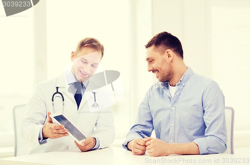 Image of doctor with tablet pc and patient in hospital