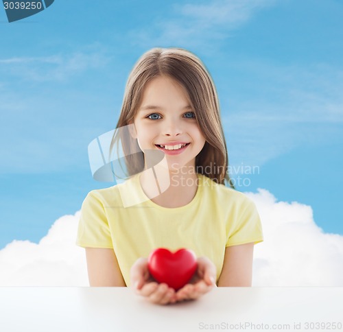 Image of beautiful little girl sitting at table