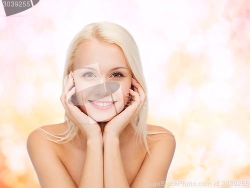 Image of beautiful woman touching her face skin