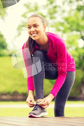 Image of smiling woman exercising outdoors