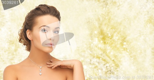 Image of beautiful woman wearing shiny diamond pendant