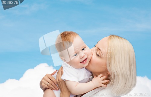 Image of happy mother kissing smiling baby