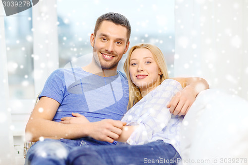 Image of happy couple hugging at home