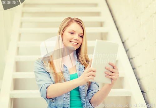 Image of smiling female student with tablet pc computer