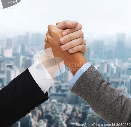 Image of hands of two people armwrestling