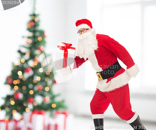 Image of man in costume of santa claus with gift box