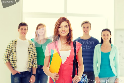 Image of smiling students with teenage girl in front