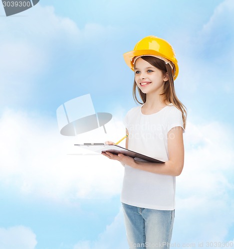 Image of smiling little girl in hardhat with clipboard