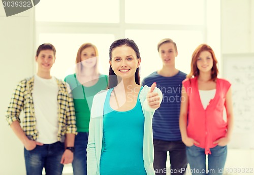 Image of smiling students with teenage girl in front