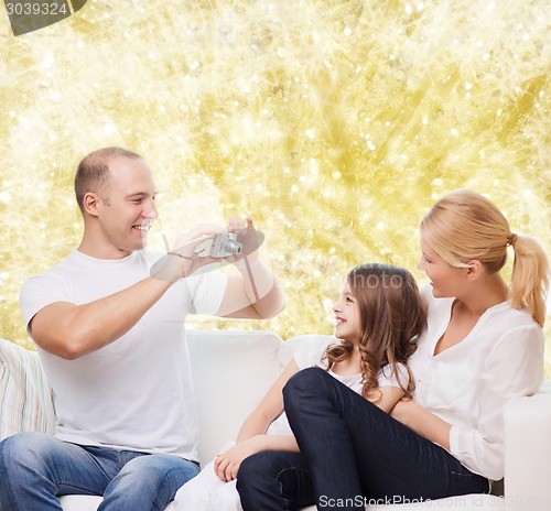 Image of happy family with camera at home