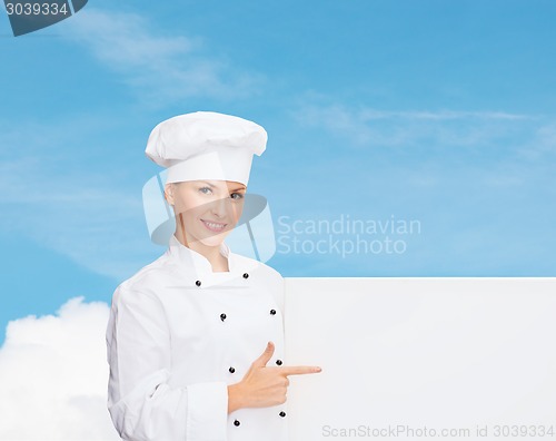 Image of smiling female chef with white blank board