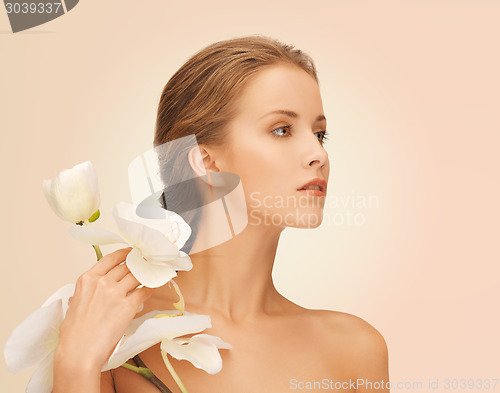 Image of beautiful young woman with orchid flowers