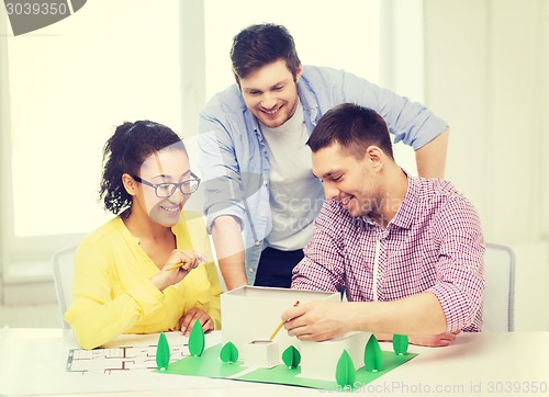 Image of smiling architects working in office